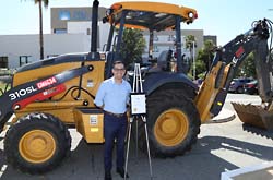 Mayor Gutierrez in front of a tractor.
