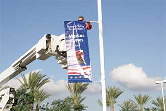 Workman installing a banner