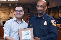 Mayor Gutierrez presenting a plaque to retiring Fire Chief Abdul Ahmad.