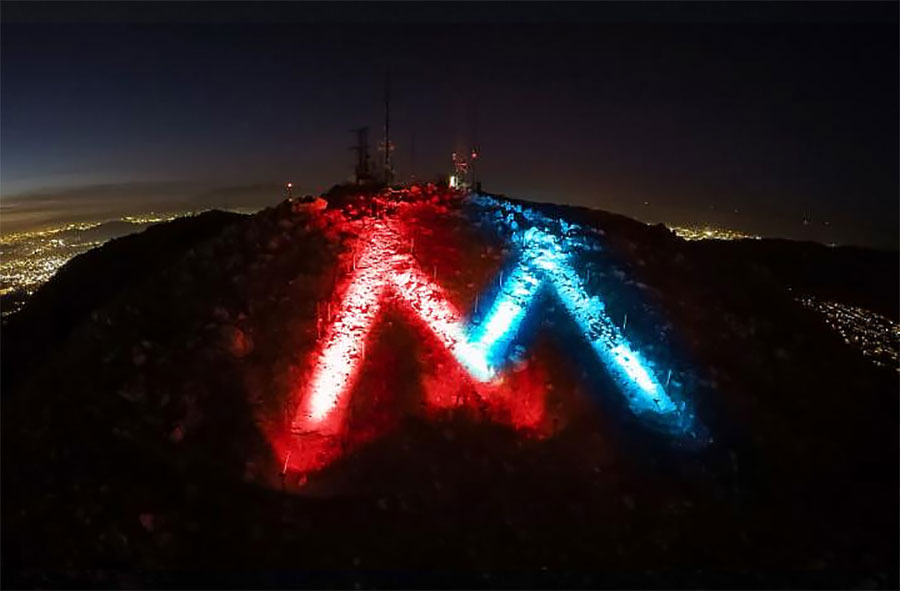 The M lit in red, white and blue colors.